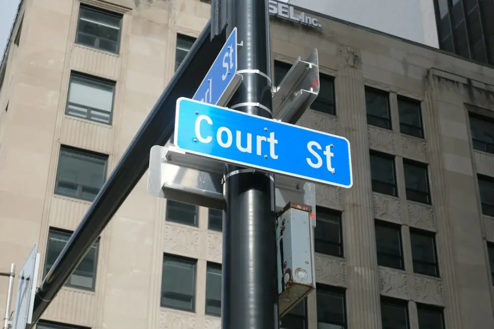 A street sign indicates "court st.", illustrating court proceedings in plain language